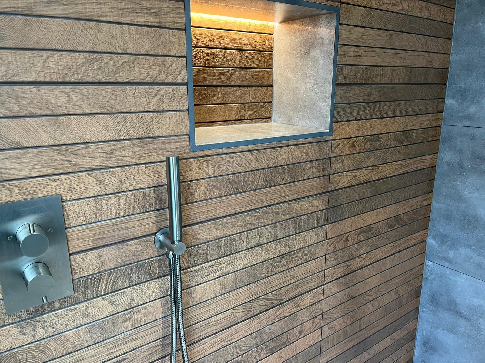 LED-lit stone-lined shower niche and concealed brushed nickel thermostatic valve